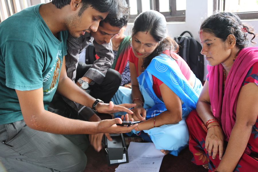 Nepal women learning to use Amakomaya mobile app