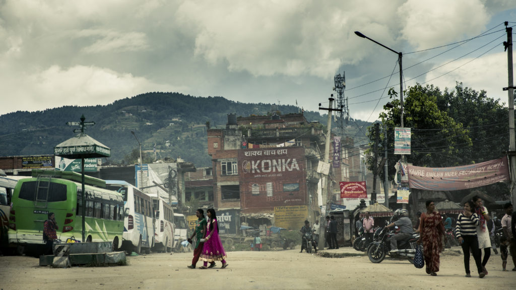 women walk across a street in Nepal